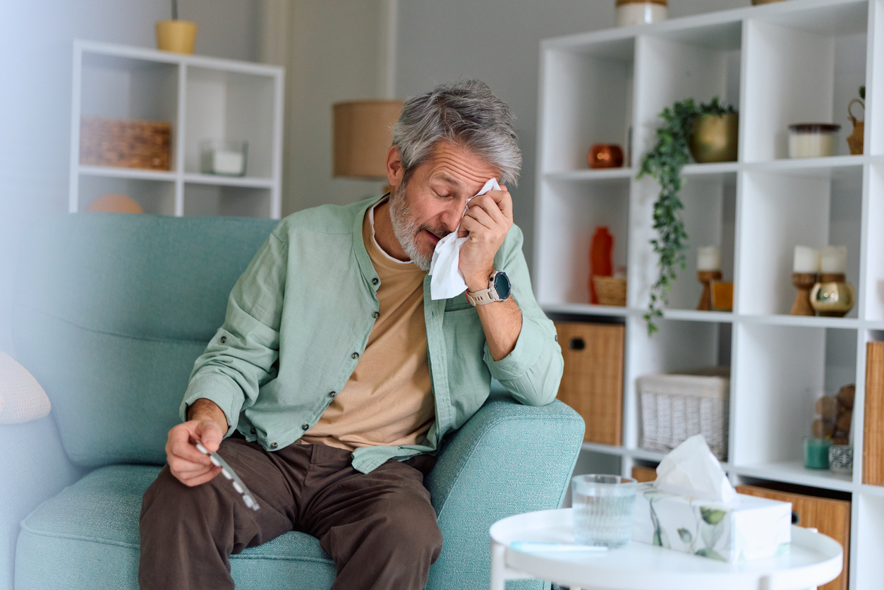 Senior man crying, feeling unwell with flu and allergy symptoms